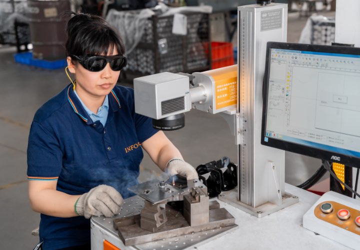 Staff operating the laser machine